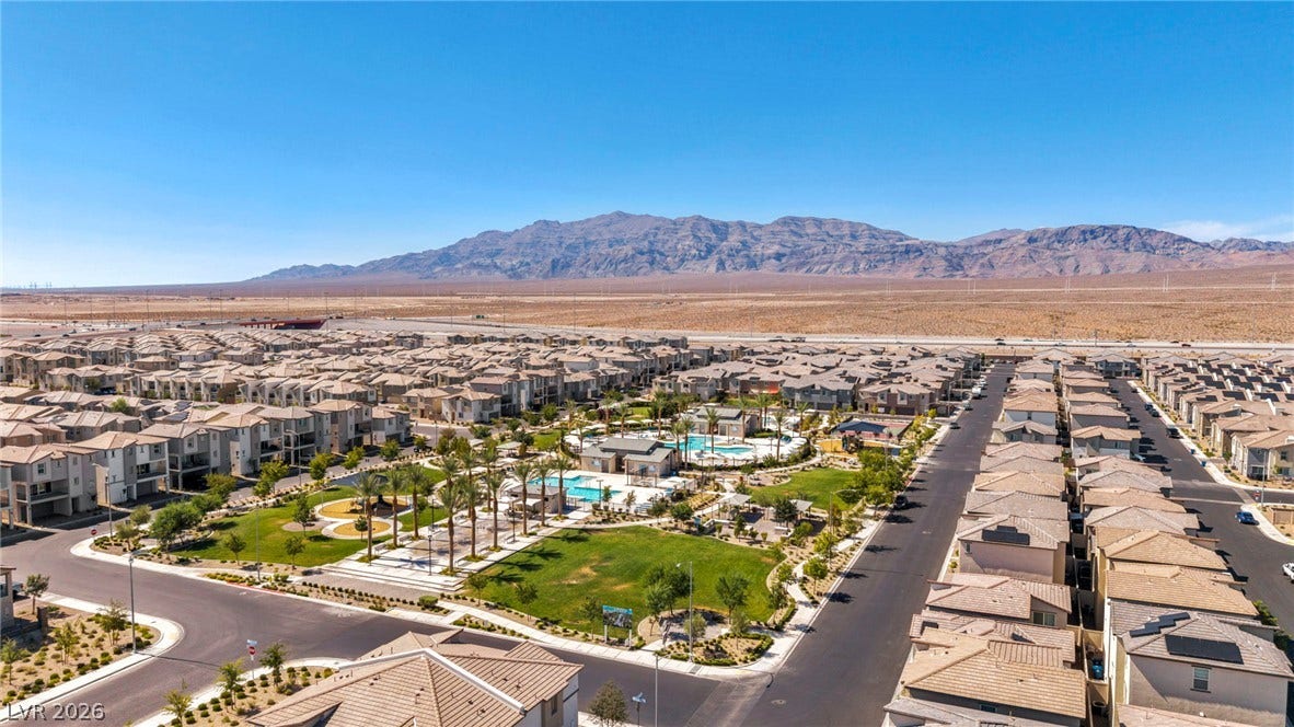 2594 Canary Yellow Court, North Las Vegas, NV 89086 An aerial view showcases a vibrant community park framed by rugged mountain vistas.