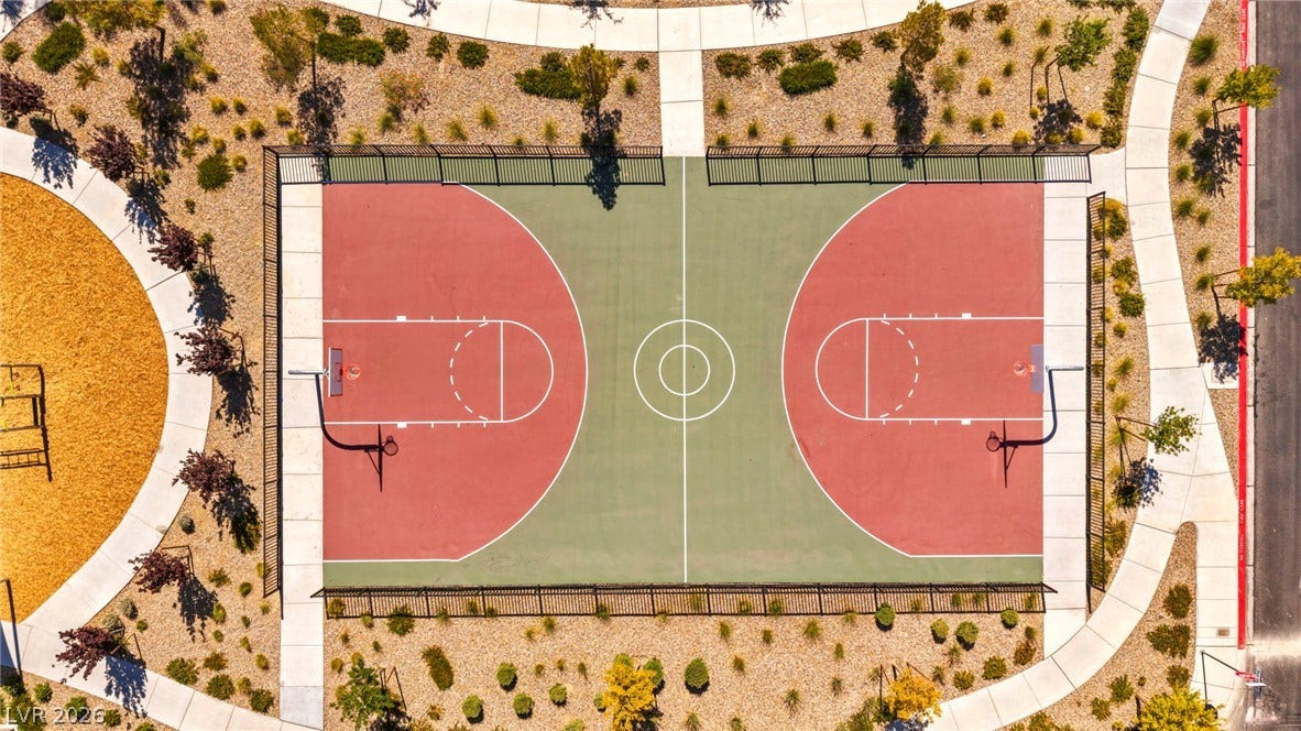 2594 Canary Yellow Court, North Las Vegas, NV 89086 An aerial perspective showcases the pristine community basketball court flanked by concrete pathways.
