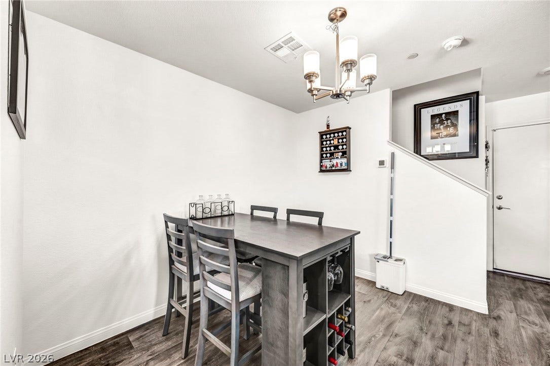 2594 Canary Yellow Court, North Las Vegas, NV 89086 Crisp white walls and handsome wood floors elevate this versatile dining space.