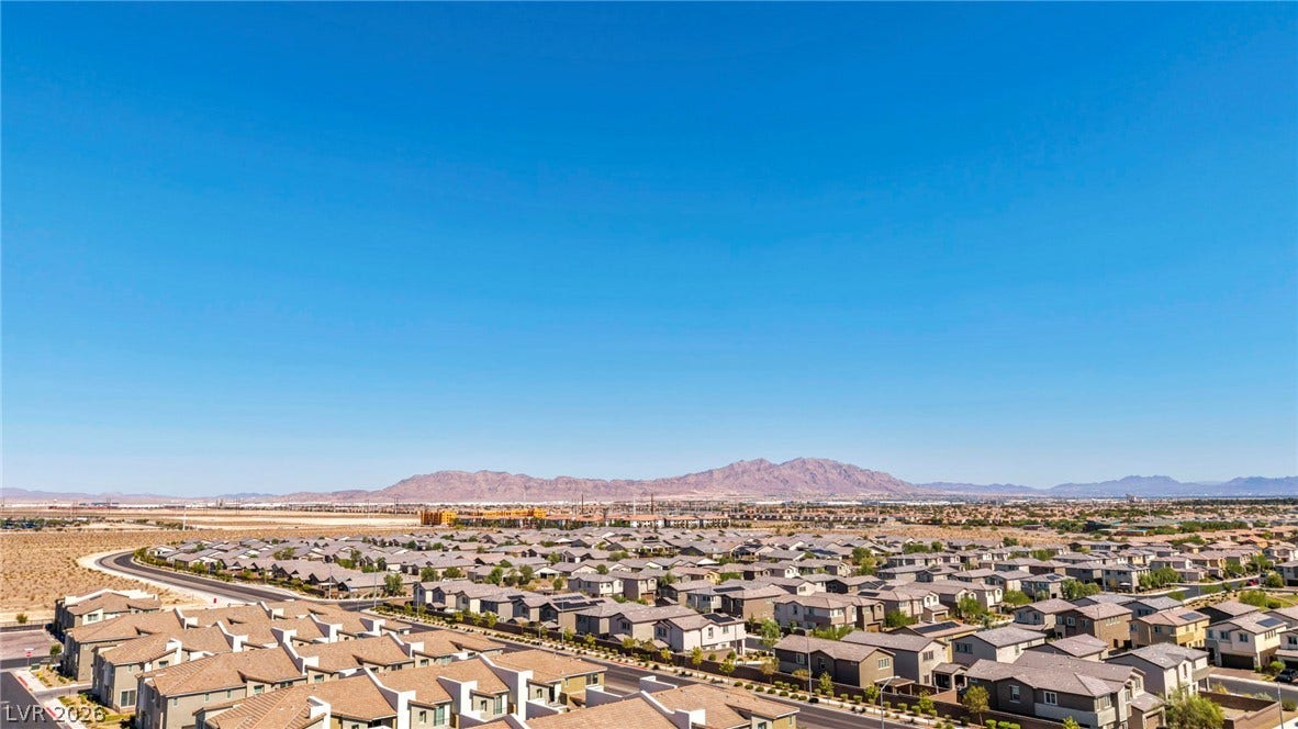 2594 Canary Yellow Court, North Las Vegas, NV 89086 Panoramic neighborhood views stretch toward distant mountains under a clear blue sky.