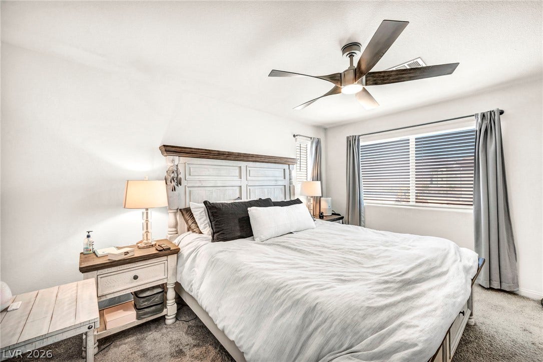 2594 Canary Yellow Court, North Las Vegas, NV 89086 Plentiful natural light streams through wide windows onto plush carpeting in this peaceful bedroom.