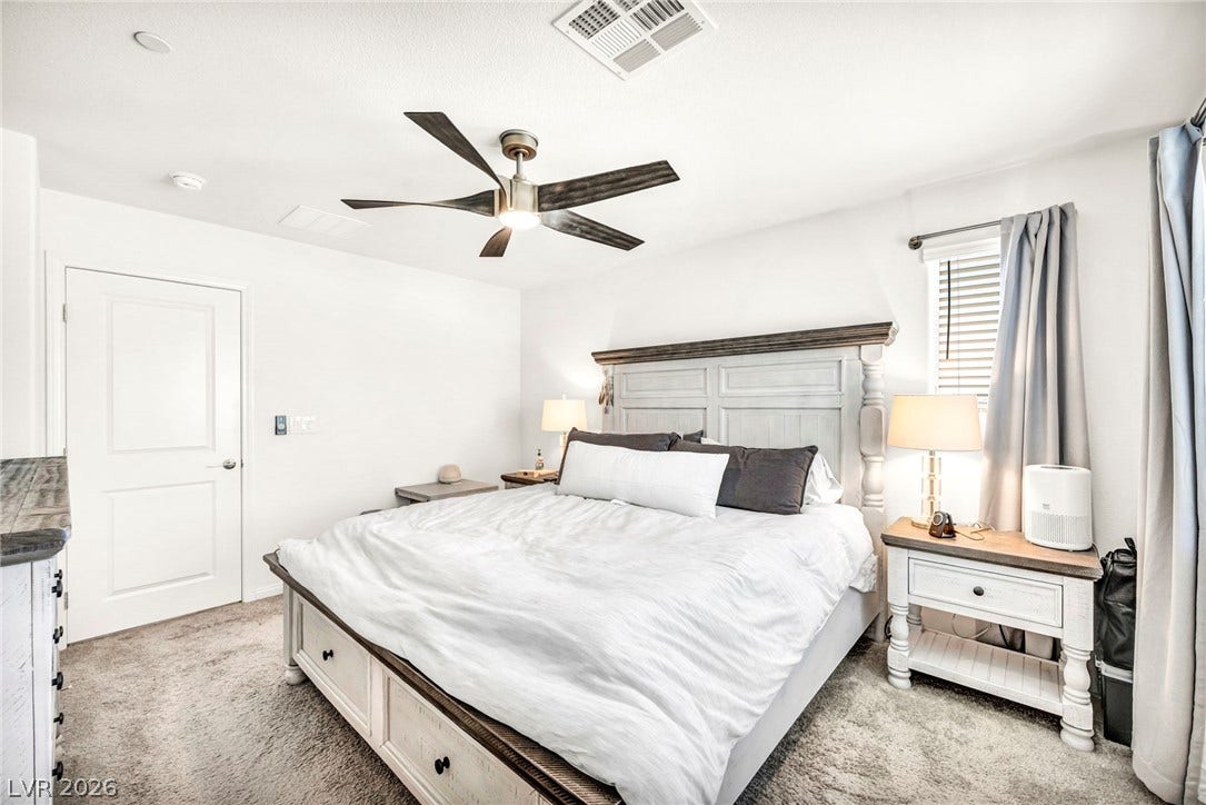 2594 Canary Yellow Court, North Las Vegas, NV 89086 Soft carpeting pairs with neat trim and windows in this relaxing sleep space.