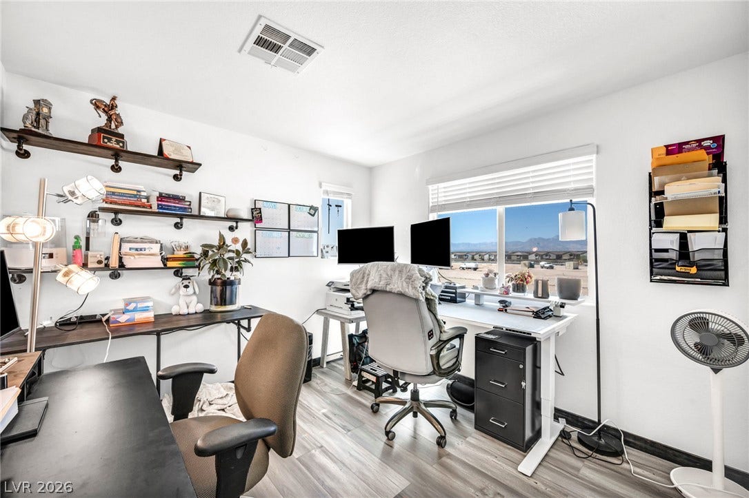2594 Canary Yellow Court, North Las Vegas, NV 89086 Upgraded floors and a wide window frame views of the distant mountains from this office.