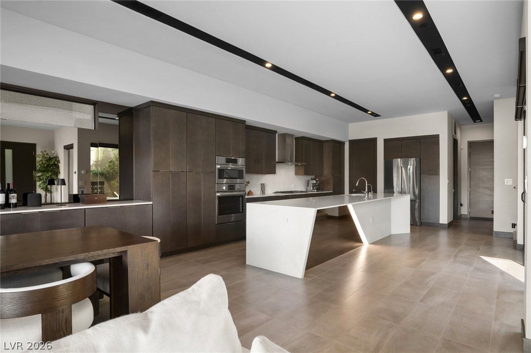 34 Lakefront Drive, Henderson, NV 89011 Minimalist design elements define this contemporary kitchen layout featuring a waterfall island.