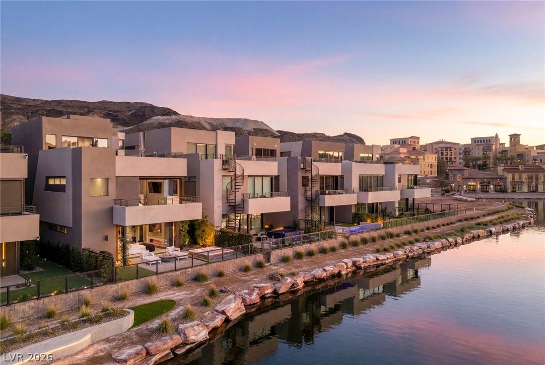 34 Lakefront Drive, Henderson, NV 89011 Modern lakeside residences feature multi-level glass balconies reflecting across the calm water.