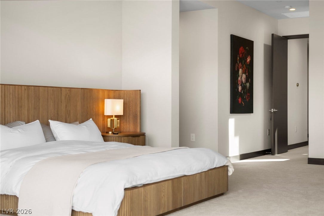 34 Lakefront Drive, Henderson, NV 89011 Smooth walls and plush carpet create a serene atmosphere in this modern bedroom.