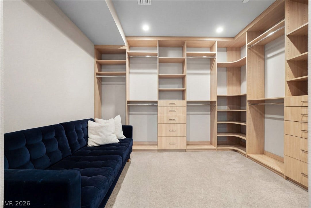 34 Lakefront Drive, Henderson, NV 89011 Custom wood shelving and soft carpeting define this spacious closet organization system.
