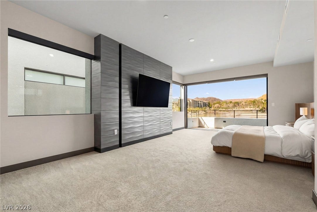 34 Lakefront Drive, Henderson, NV 89011 High ceilings and a wall of glass frame scenic outdoor views from this spacious suite.