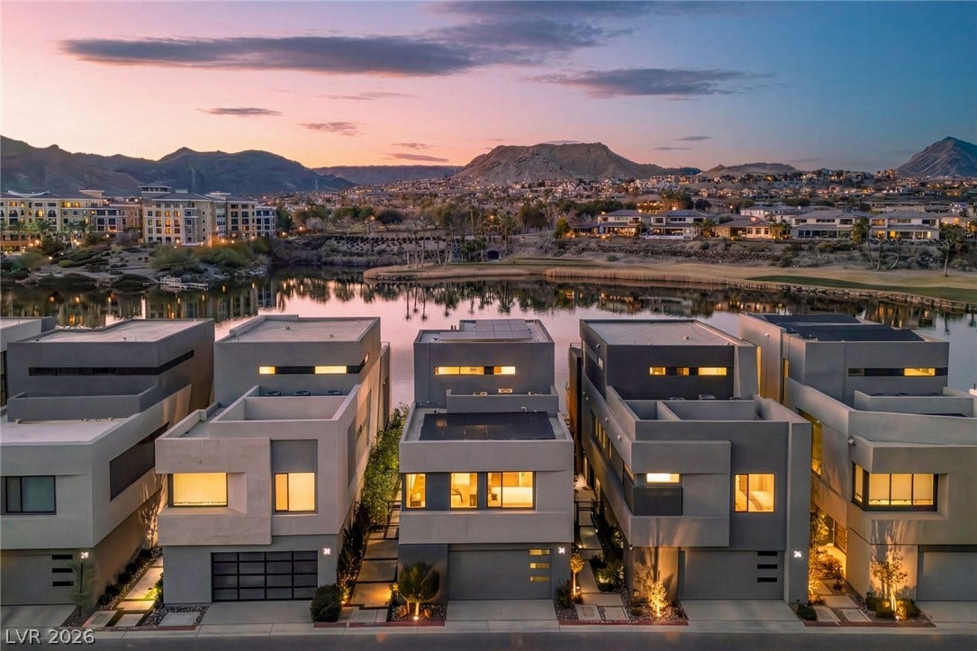 34 Lakefront Drive, Henderson, NV 89011 Modern lakeside residences sit gracefully against a backdrop of majestic mountains and sunset skies.
