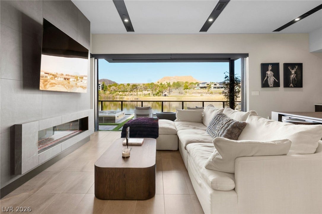 34 Lakefront Drive, Henderson, NV 89011 A modern fireplace wall faces sliding glass doors that open to sweeping lake views.