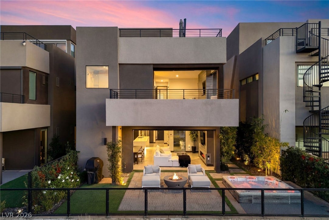 34 Lakefront Drive, Henderson, NV 89011 Sleek multi-level design creates an inviting backyard retreat under a twilight sky.