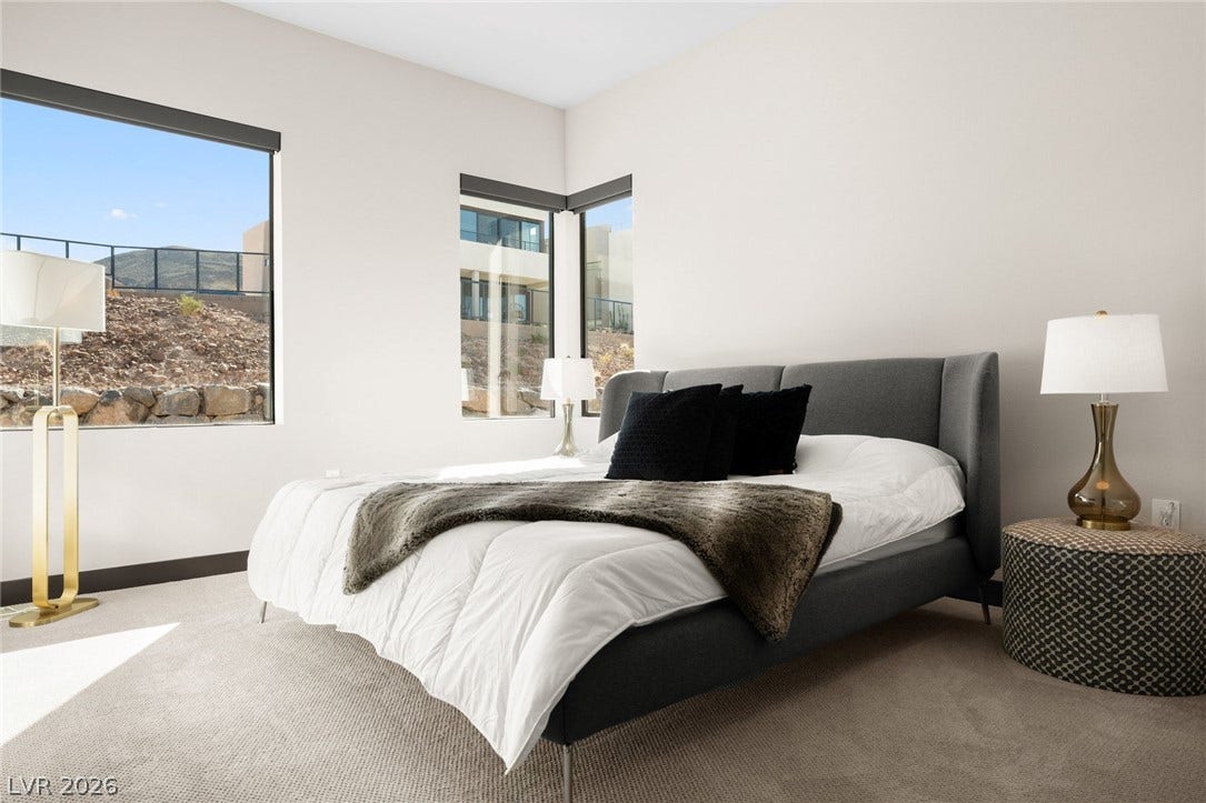 34 Lakefront Drive, Henderson, NV 89011 Generous window openings frame desert hillside views from this serene bedroom retreat.