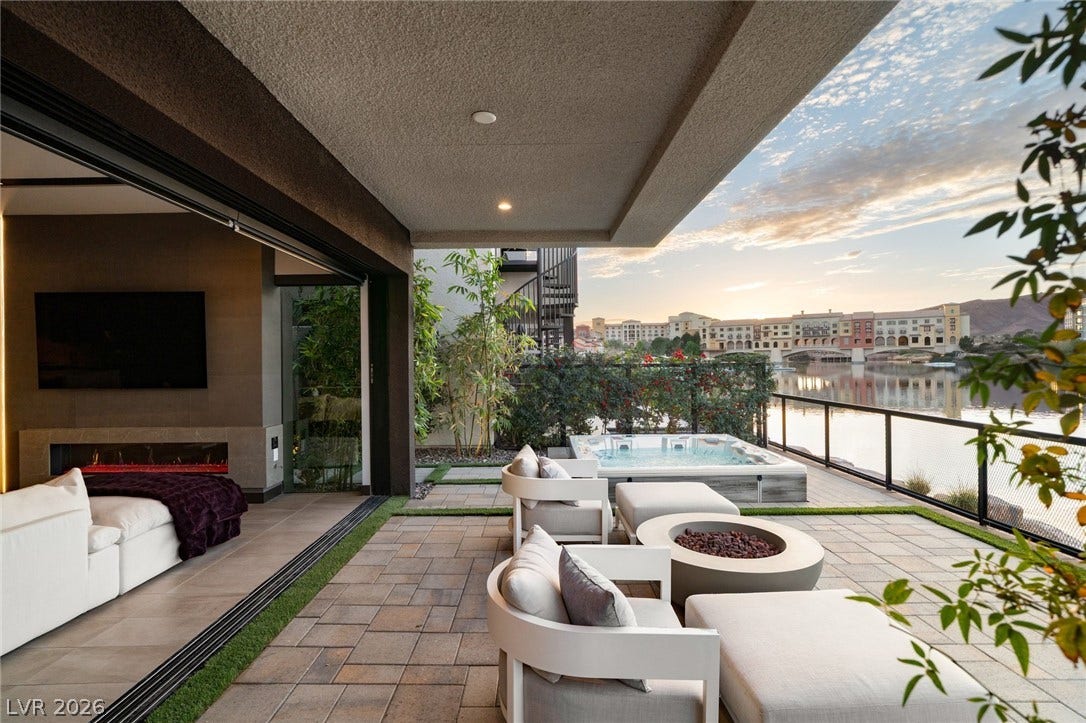 34 Lakefront Drive, Henderson, NV 89011 A spacious stone paved terrace overlooks calm water and features an integrated spa tub.