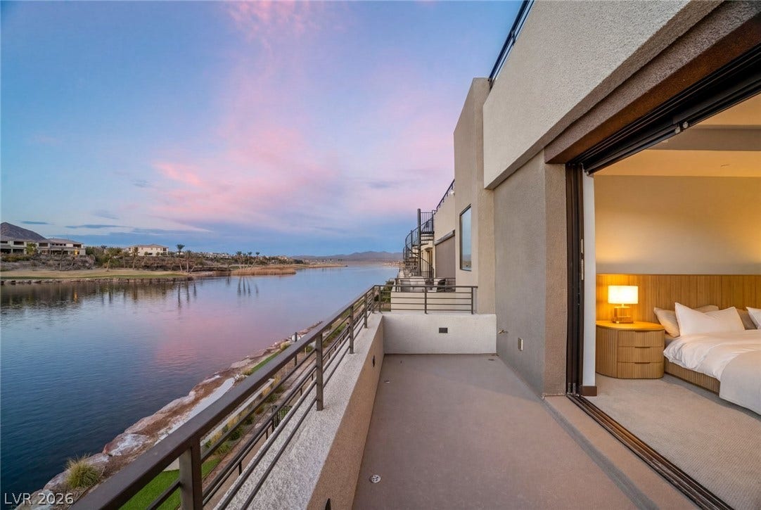 34 Lakefront Drive, Henderson, NV 89011 Sliding doors connect the serene bedroom suite directly to a private waterfront balcony.