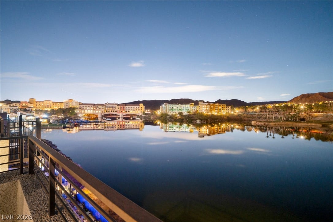 34 Lakefront Drive, Henderson, NV 89011 Serene evening views overlook the water with distant architectural lights reflecting on the glassy surface.