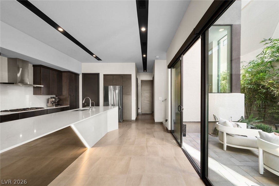 34 Lakefront Drive, Henderson, NV 89011 Sleek sliding glass doors connect this contemporary kitchen to an inviting outdoor courtyard.