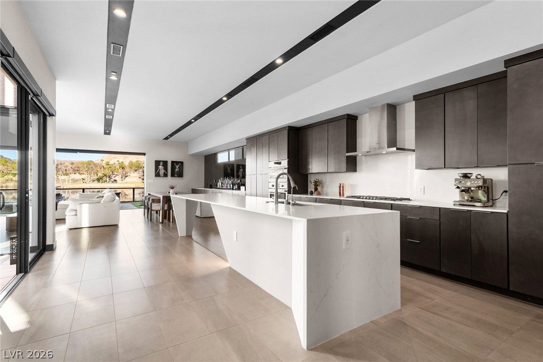 34 Lakefront Drive, Henderson, NV 89011 An open-concept kitchen features a waterfall island and sleek modern cabinetry.