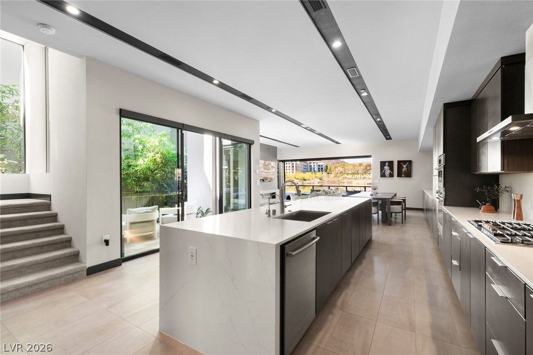 34 Lakefront Drive, Henderson, NV 89011 Gleaming stone countertops and modern cabinetry highlight this open-concept kitchen.