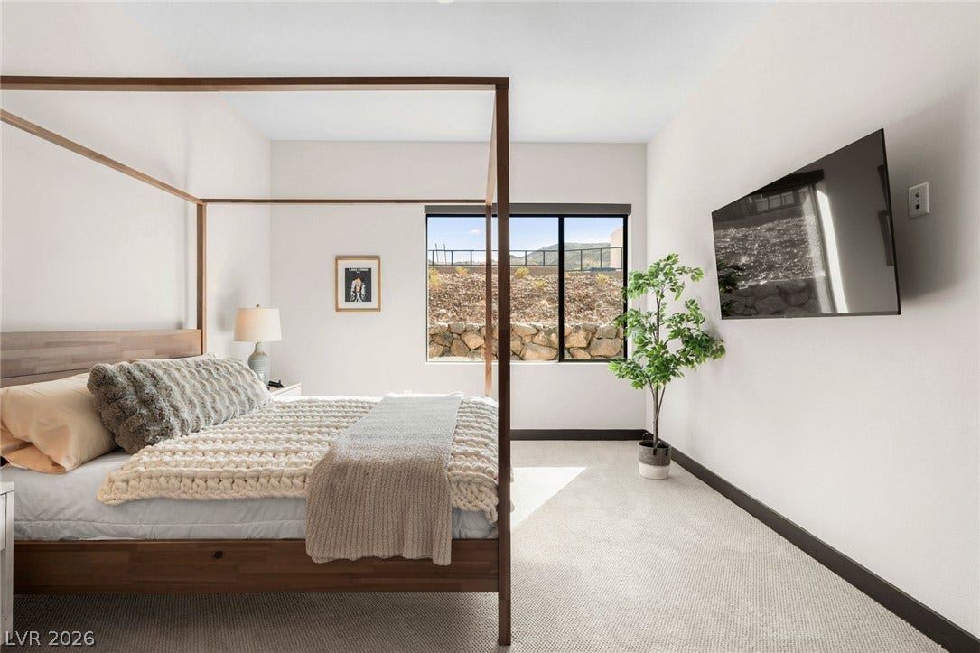 34 Lakefront Drive, Henderson, NV 89011 Natural light pours through a large window overlooking the terraced stone wall outside.