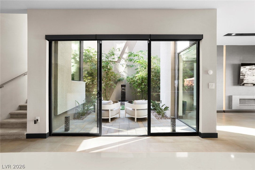 34 Lakefront Drive, Henderson, NV 89011 Large sliding glass doors open directly to a private, sun-drenched central courtyard.