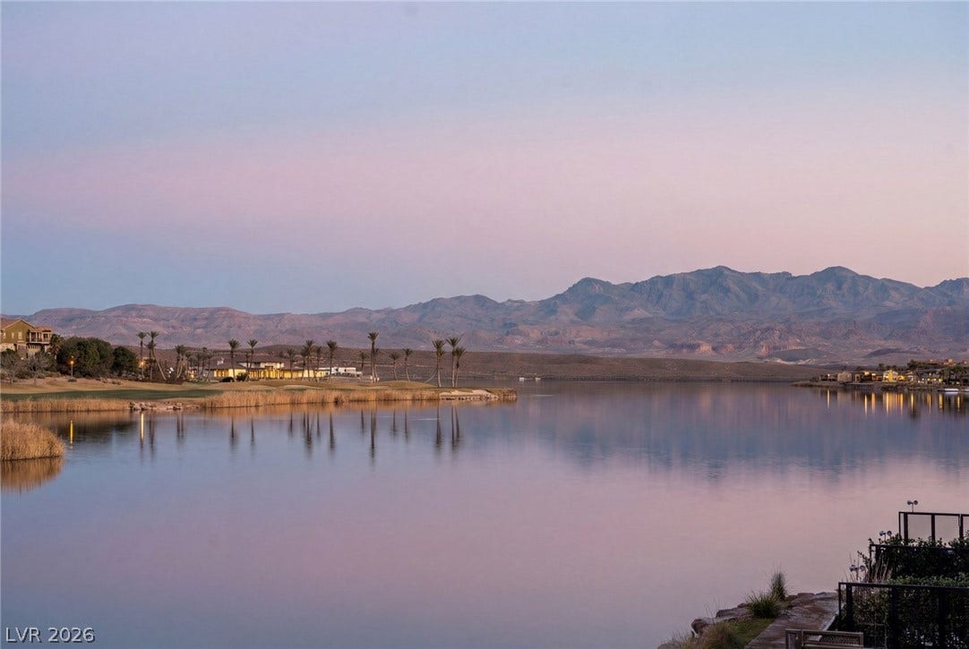 34 Lakefront Drive, Henderson, NV 89011 Serene water reflections mirror the distant mountain ridges under a soft pastel twilight sky.