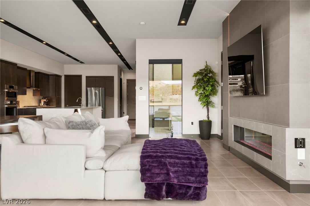 34 Lakefront Drive, Henderson, NV 89011 Clean lines and a modern fireplace define this open living area with large-format tile flooring.