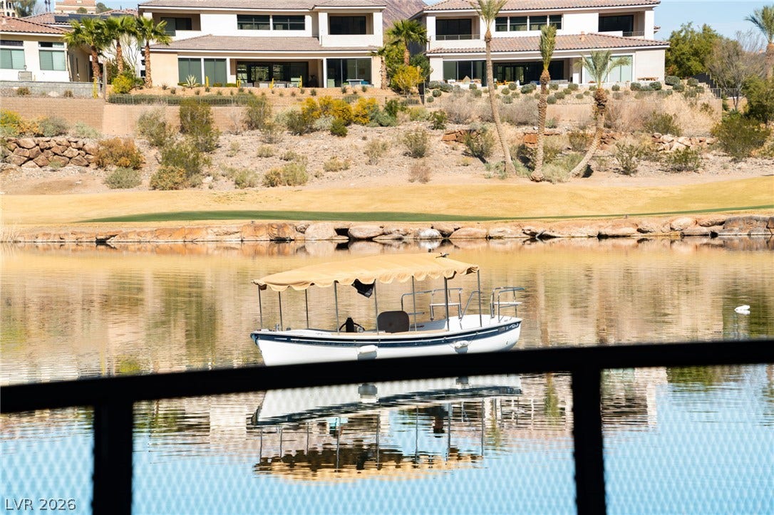34 Lakefront Drive, Henderson, NV 89011 Serene waterfront views overlook the calm lake and neighboring hillsides.