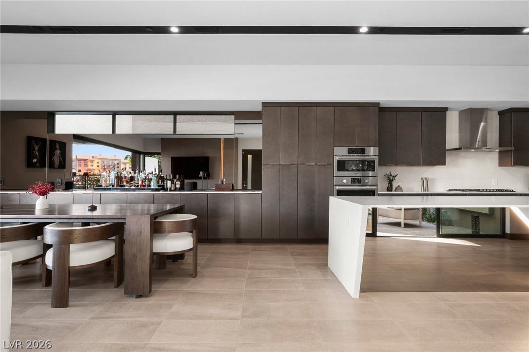 34 Lakefront Drive, Henderson, NV 89011 Clean lines and stone flooring anchor this modern culinary space and dining area.
