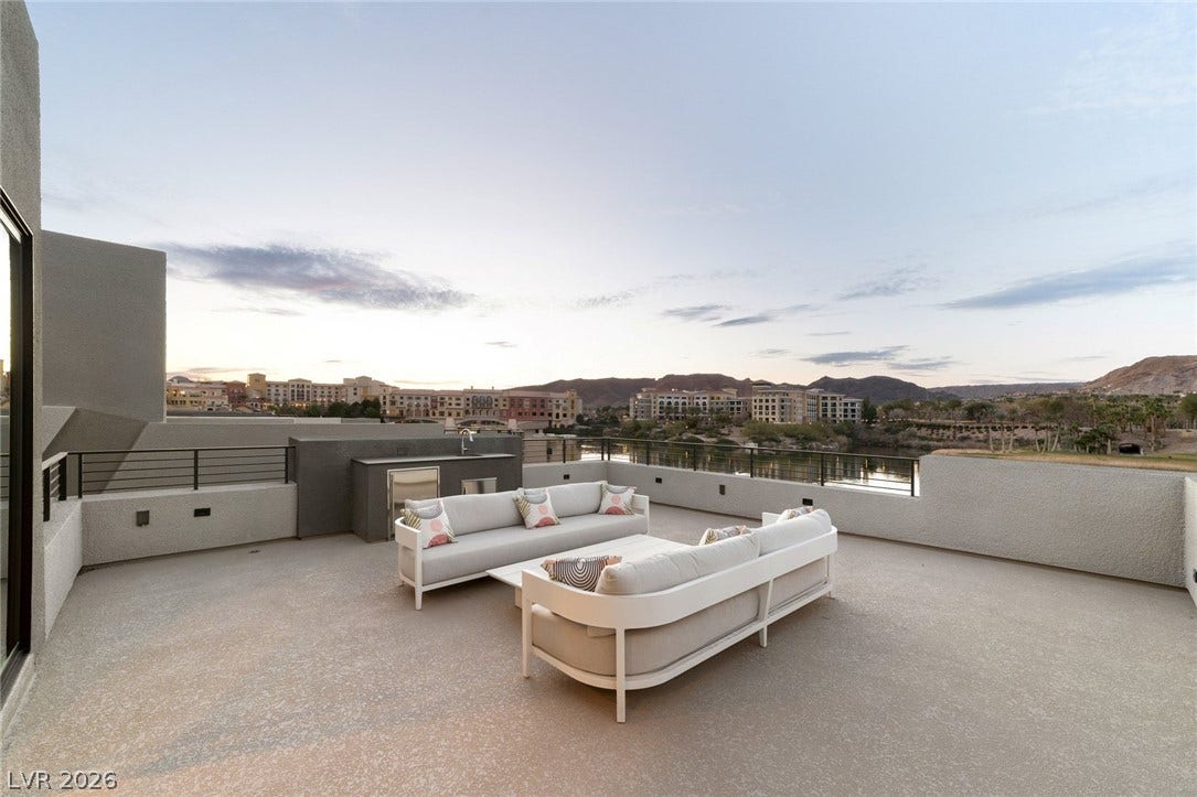 34 Lakefront Drive, Henderson, NV 89011 Panoramic mountain and water views elevate this spacious outdoor terrace.