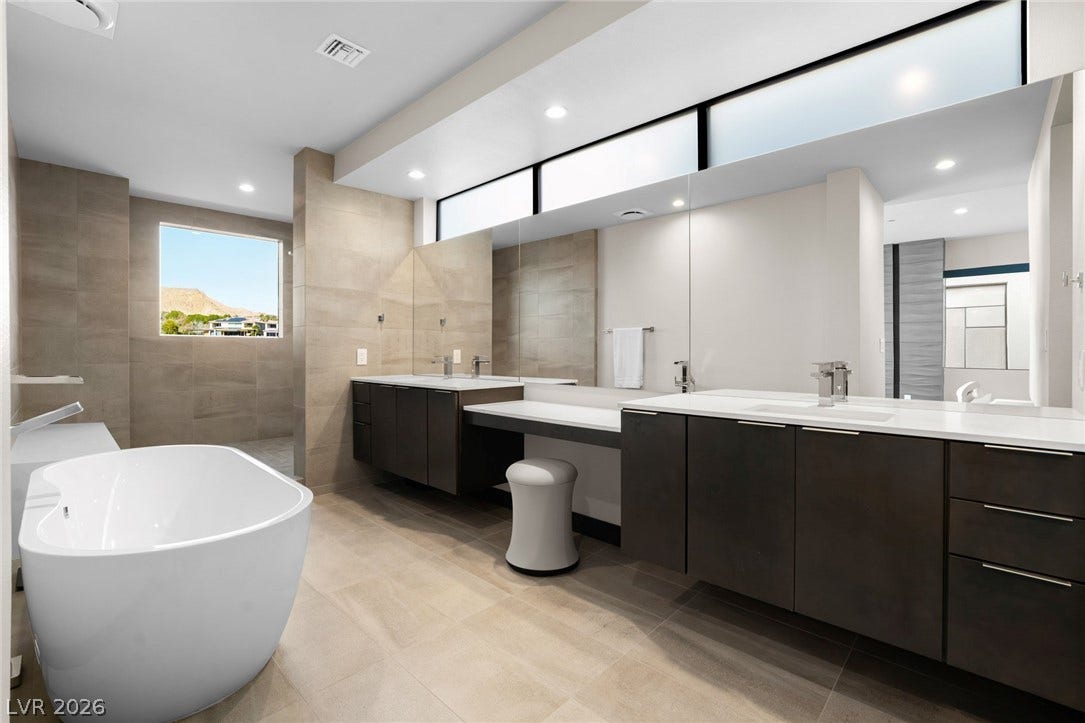 34 Lakefront Drive, Henderson, NV 89011 Clean lines and a freestanding tub define this contemporary primary bath oasis.
