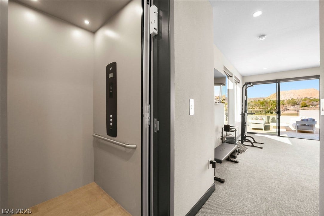 34 Lakefront Drive, Henderson, NV 89011 A private elevator seamlessly connects the home levels, opening next to a versatile recreation space.