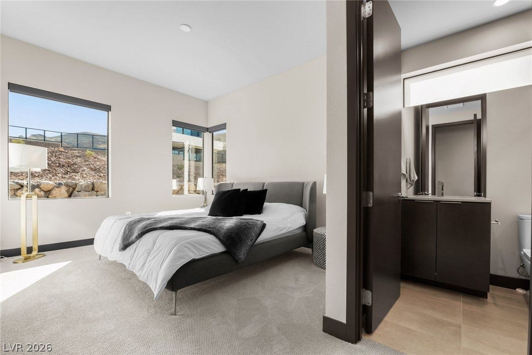34 Lakefront Drive, Henderson, NV 89011 An inviting bedroom suite flows effortlessly into an adjacent private bathroom with modern finishes.