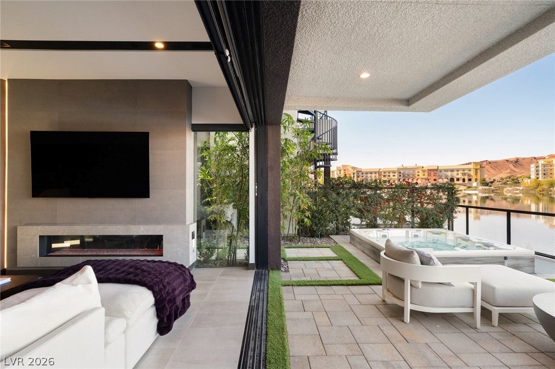 34 Lakefront Drive, Henderson, NV 89011 Seamless indoor-outdoor transitions lead to a covered patio complete with an integrated spa.