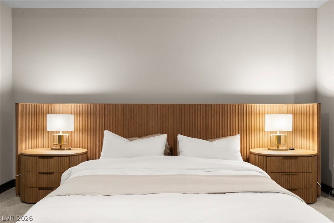 34 Lakefront Drive, Henderson, NV 89011 A built-in wooden headboard frames this bedroom with warmth and clean architectural lines.
