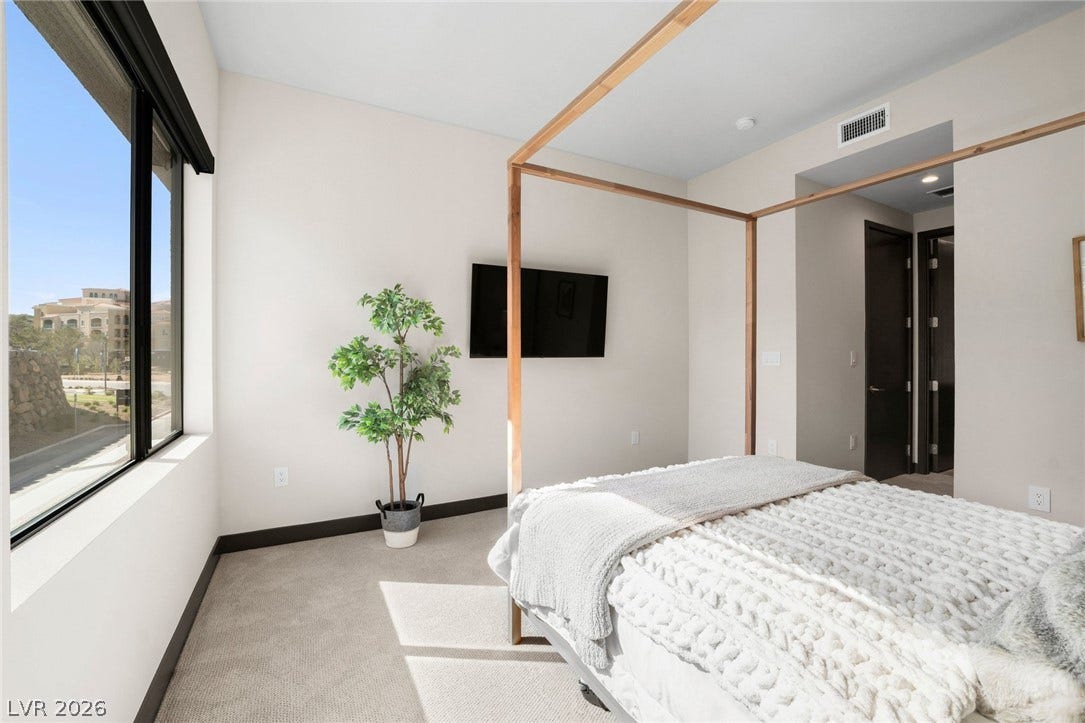 34 Lakefront Drive, Henderson, NV 89011 Large windows fill this modern bedroom with abundant natural light.