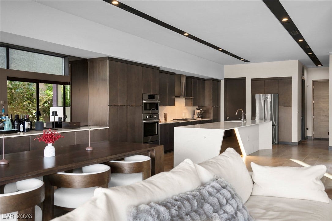 34 Lakefront Drive, Henderson, NV 89011 Sleek contemporary cabinetry and a massive waterfall island anchor this open-concept culinary space.