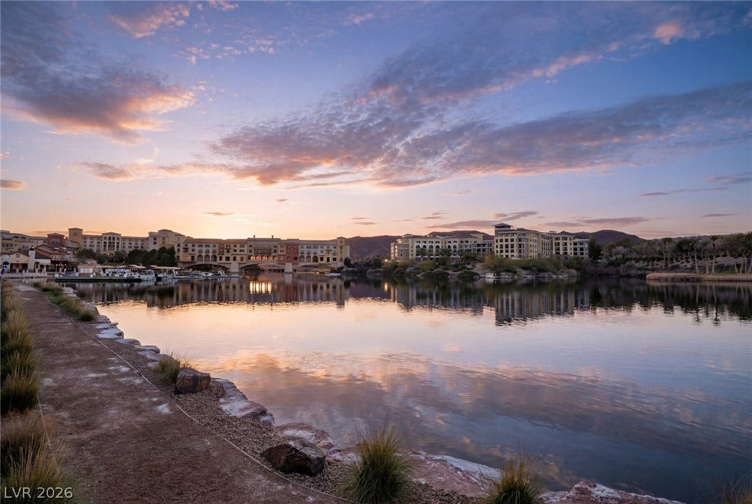 34 Lakefront Drive, Henderson, NV 89011 Serene waterfront views showcase a picturesque shoreline under a pastel sky.
