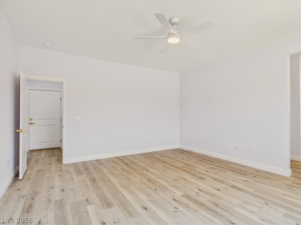 6680 S Raintree Court, Pahrump, NV 89061 Smooth wood floors anchor this clean, open room with minimal architectural details.