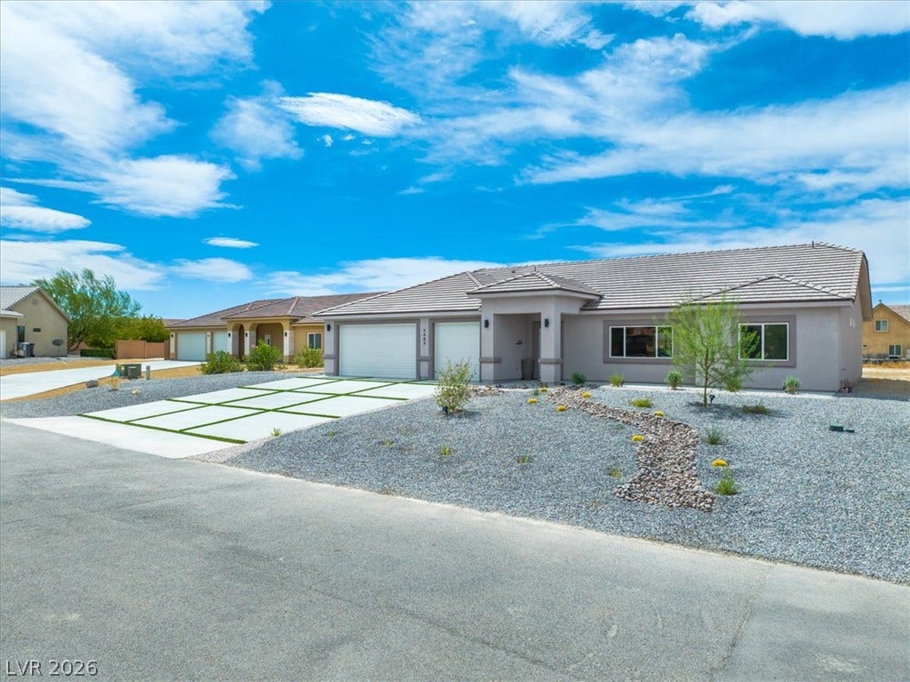 6680 S Raintree Court, Pahrump, NV 89061 Neat desert landscaping pairs perfectly with the modern architecture of this single-story home.