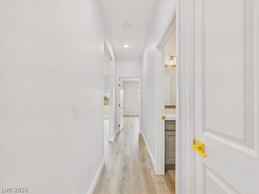 6680 S Raintree Court, Pahrump, NV 89061 Sleek wood flooring and recessed lighting define this clean, modern hallway layout.