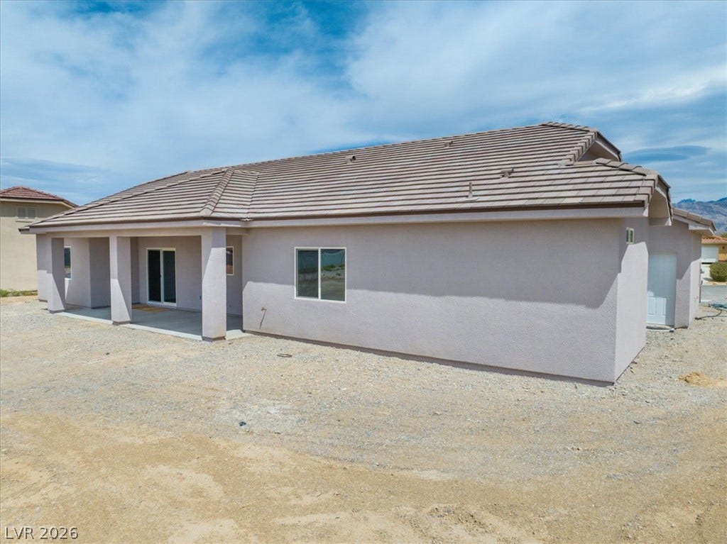 6680 S Raintree Court, Pahrump, NV 89061 A covered back porch offers a shaded outdoor retreat under a tile roof.