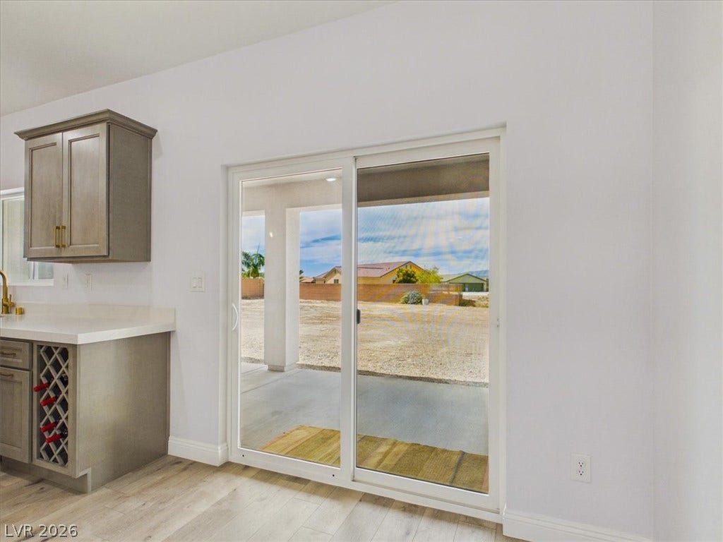 6680 S Raintree Court, Pahrump, NV 89061 Sliding glass doors frame views of the patio and lead directly from the kitchen area.
