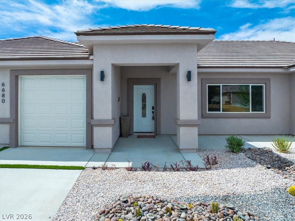 6680 S Raintree Court, Pahrump, NV 89061 An inviting entryway and low-maintenance desert landscaping define the exterior of this modern home.