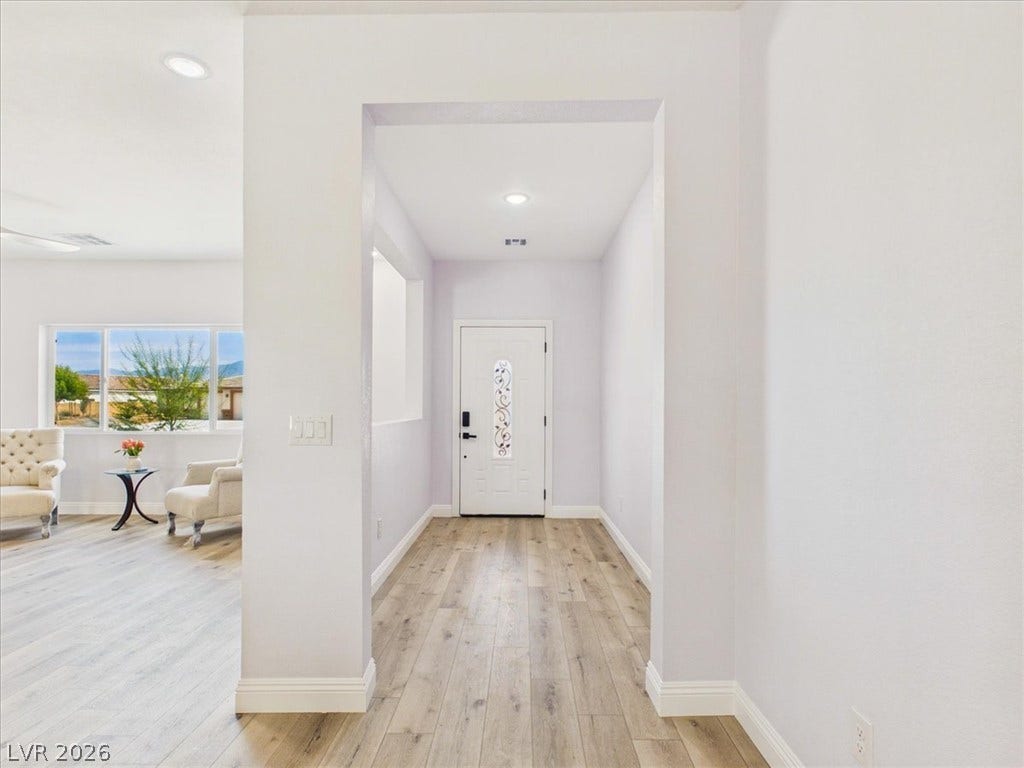 6680 S Raintree Court, Pahrump, NV 89061 Smooth wood flooring flows throughout this welcoming entrance, creating a seamless connection between spaces.