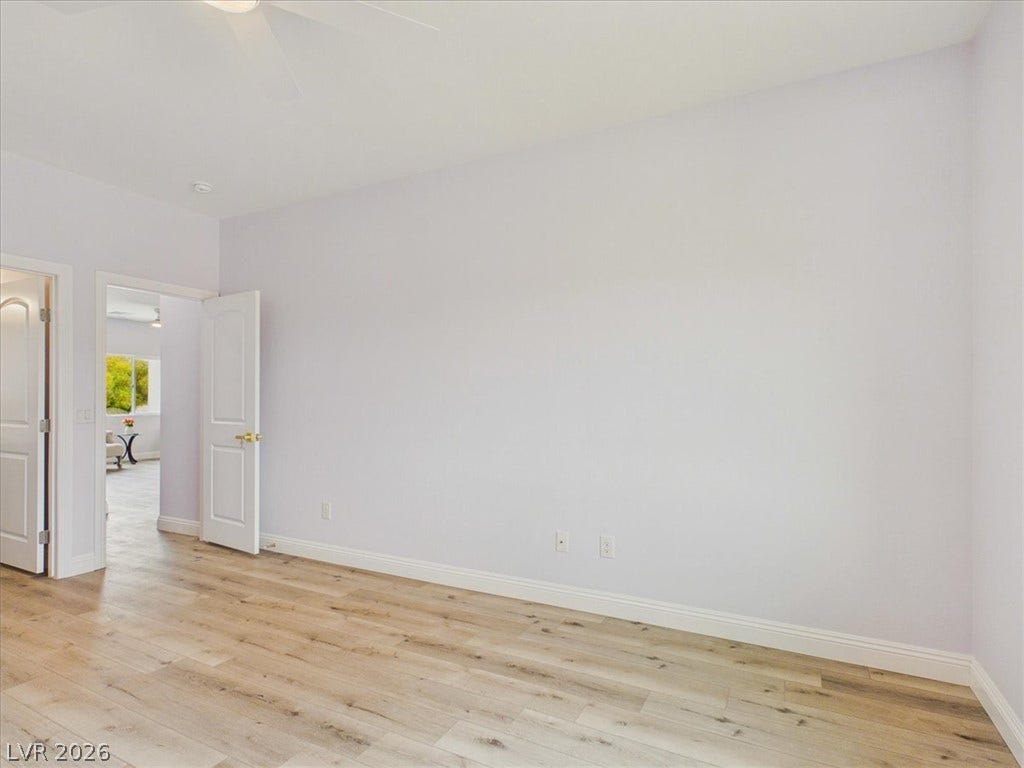 6680 S Raintree Court, Pahrump, NV 89061 Smooth wood flooring highlights this versatile empty space.