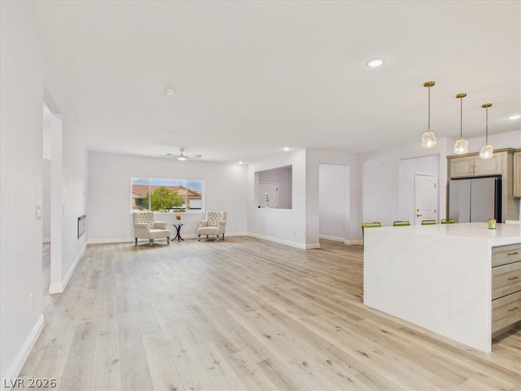 6680 S Raintree Court, Pahrump, NV 89061 An open floorplan seamlessly connects the airy living spaces over beautiful wood-style flooring.