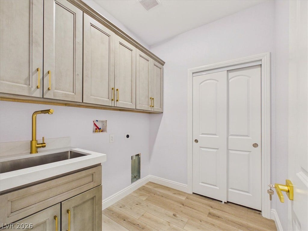 6680 S Raintree Court, Pahrump, NV 89061 Ample cabinetry and a utility sink highlight this functional home workspace.
