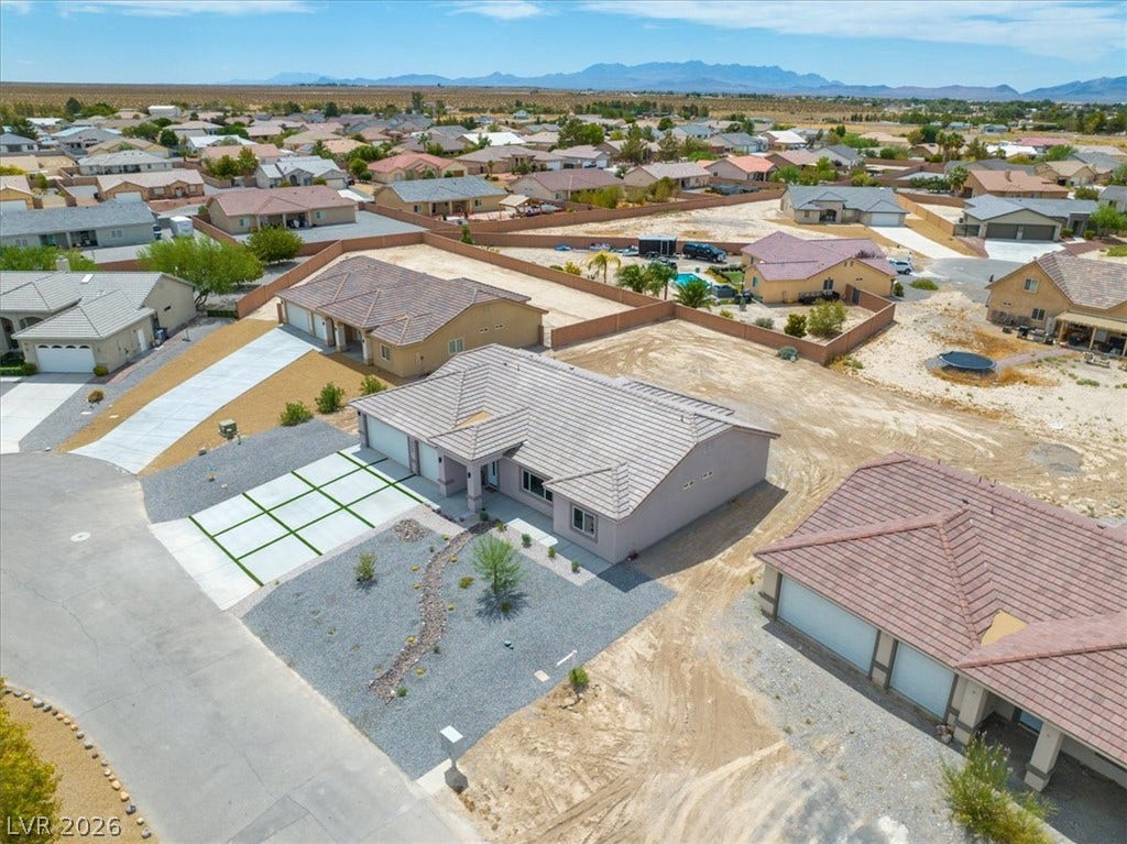 6680 S Raintree Court, Pahrump, NV 89061 Distant mountains frame this residential neighborhood featuring tile roofs and desert landscaping.