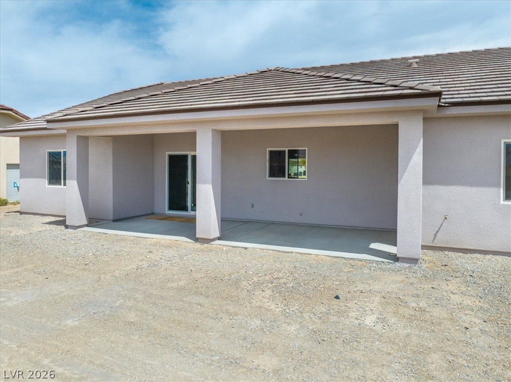 6680 S Raintree Court, Pahrump, NV 89061 A spacious covered concrete patio transitions smoothly from the stucco home exterior.