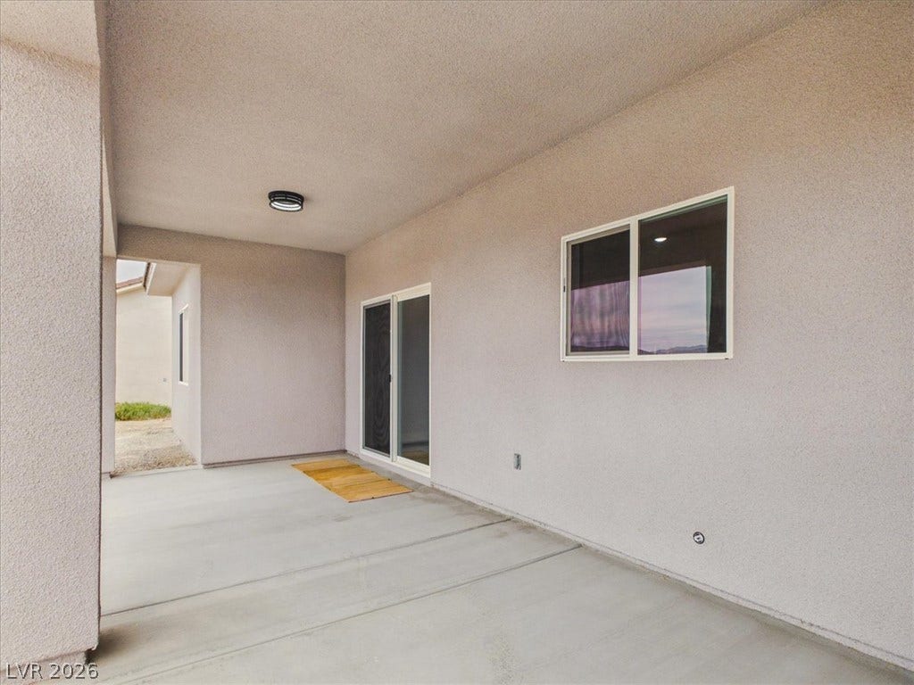 6680 S Raintree Court, Pahrump, NV 89061 Smooth concrete floors and structured stucco walls define this sheltered outdoor patio space.